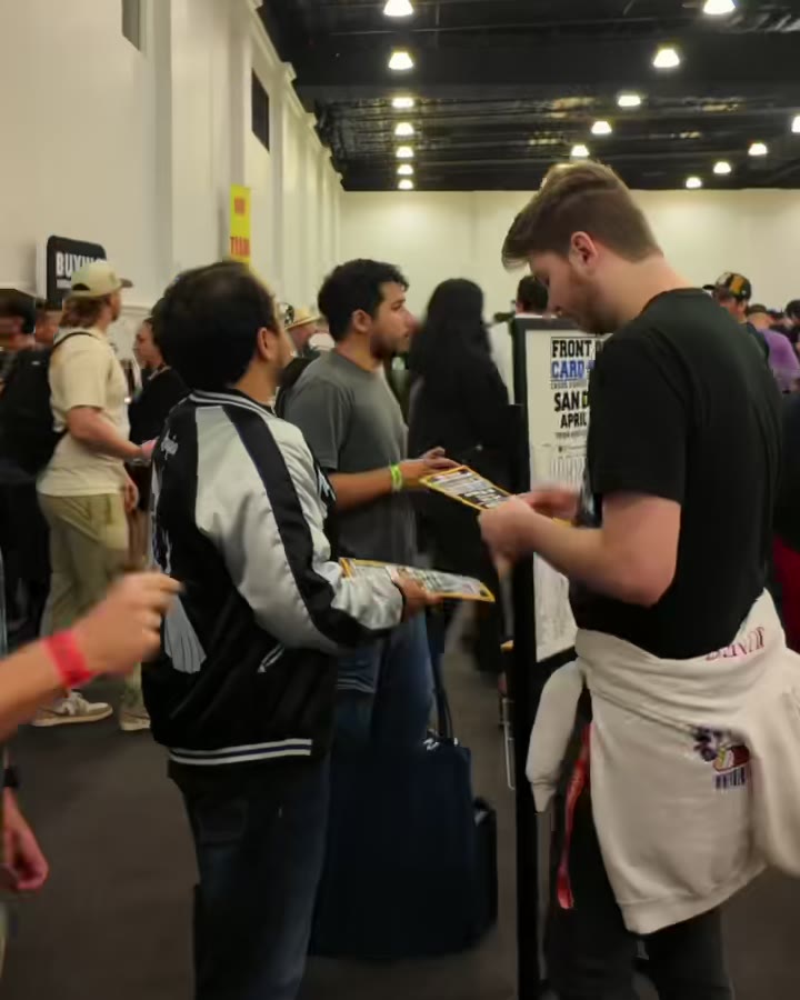 Collectors browsing an aisle of vendor tables