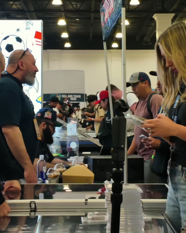 Collectors browsing packed display cases